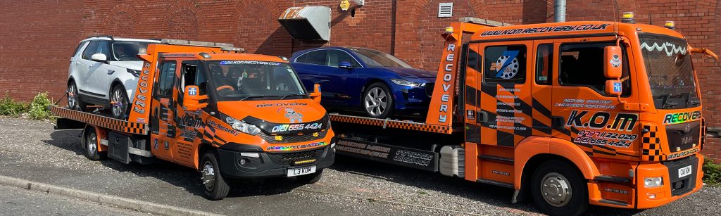 Orange K.O.M recovery vehicles lined up together